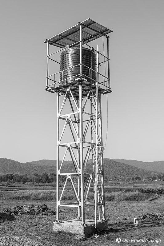 Single Village Scheme infrastructure showing an Overhead Tank lodged in a steel structure and solar power panels under Jal Jeevan Mission in Jharkhand, India
